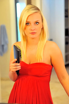 Cat plays with her comb